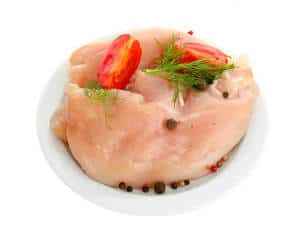 Chicken meat covered with tomato in white plate,isolated on white background